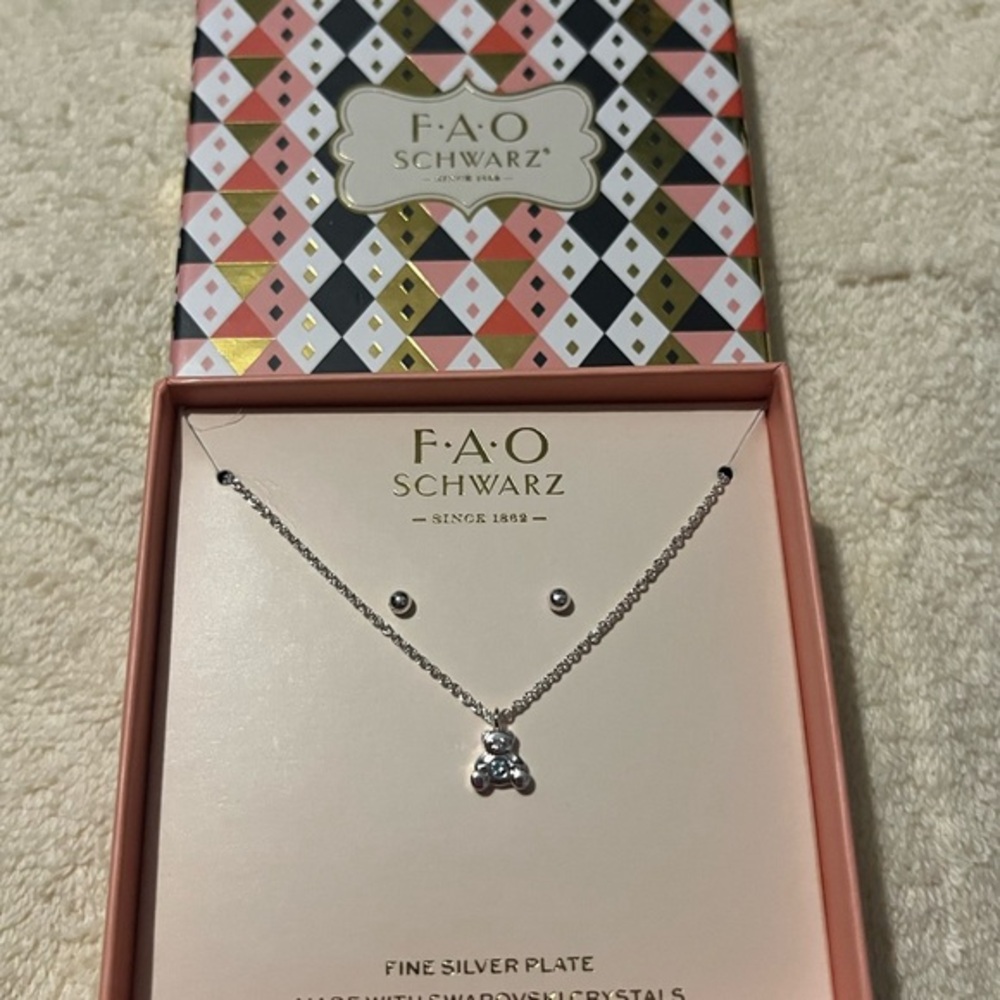 FAO Schwarz blue crystal in the teddy bear necklace with stud earrings.